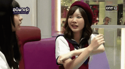 A Woman In A Red Beret Is Talking To Another Woman GIF