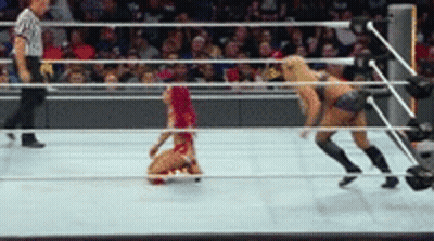 A Woman In A Red Bikini Is Kneeling On The Floor In A Wrestling Ring GIF