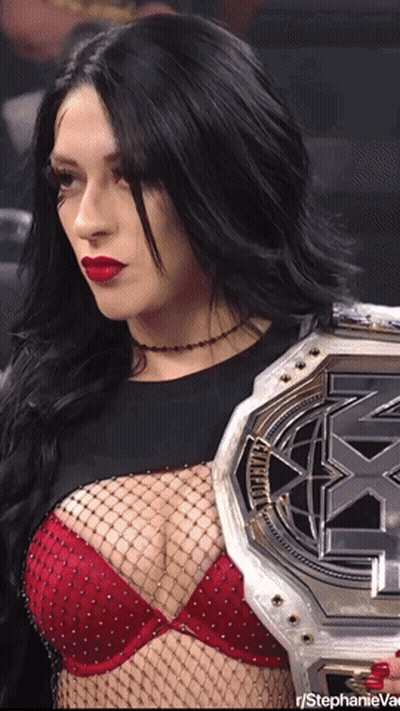 A Woman In A Red Bra Is Holding A X-Match Championship Belt GIF