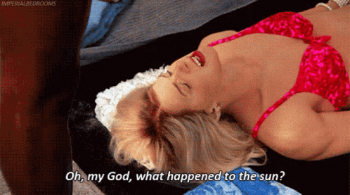 A Woman In A Red Bra Is Laying On A Bed With Her Mouth Open And Says Oh My God What Happened To The Sun GIF