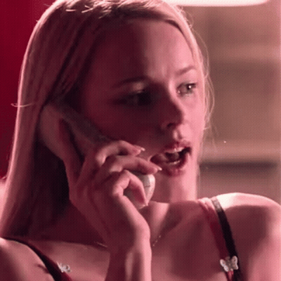A Woman In A Red Bra Is Talking On A Cell Phone With Her Mouth Open . GIF