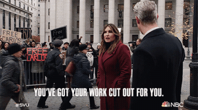 A Woman In A Red Coat Stands Next To A Man In A Black Suit And Says You 'Ve Got Your Work Cut Out GIF