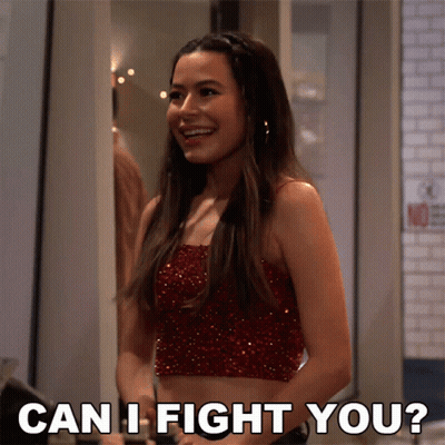A Woman In A Red Crop Top Is Smiling And Asking " Can I Fight You " GIF