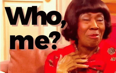 A Woman In A Red Dress Has Her Eyes Closed And Says Who Me GIF