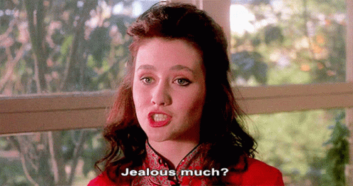A Woman In A Red Dress Is Asking If She Is Jealous GIF