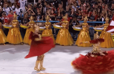 A Woman In A Red Dress Is Dancing In Front Of A Crowd Wearing A Staff Shirt GIF