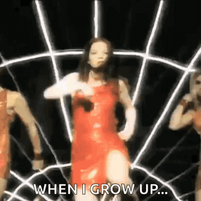 A Woman In A Red Dress Is Dancing In Front Of A Spider Web With The Words `` When I Grow Up ... '' GIF