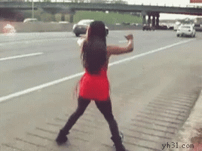 A Woman In A Red Dress Is Dancing On A Highway GIF