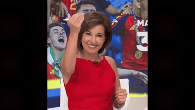A Woman In A Red Dress Is Giving A Middle Finger In Front Of A Soccer Team . GIF