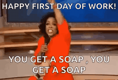 A Woman In A Red Dress Is Holding A Microphone And Saying `` Happy First Day Of Work ! '' GIF