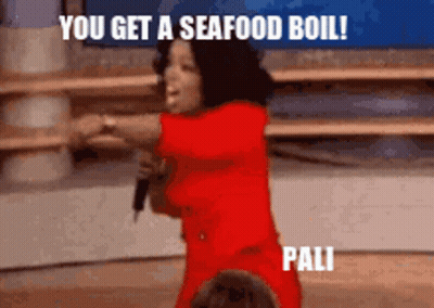 A Woman In A Red Dress Is Holding A Microphone And Saying " You Get A Seafood Boil " GIF