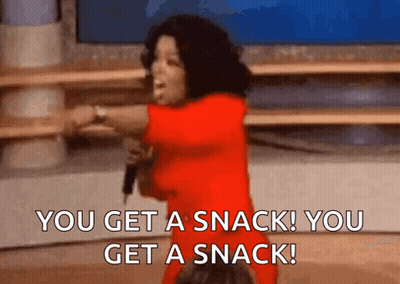 A Woman In A Red Dress Is Holding A Microphone And Saying You Get A Snack You Get A Snack . GIF