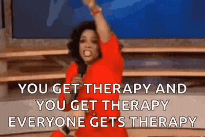 A Woman In A Red Dress Is Holding A Microphone And Saying You Get Therapy And You Get Therapy Everyone Gets Therapy . GIF