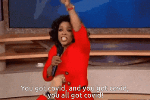 A Woman In A Red Dress Is Holding A Microphone And Saying You Got Covid GIF