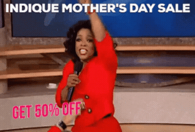 A Woman In A Red Dress Is Holding A Microphone In Front Of A Sign That Says Indice Mother 'S Day GIF