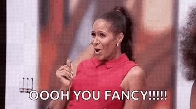 A Woman In A Red Dress Is Holding A Pair Of Glasses And Saying Oooh You Fancy . GIF