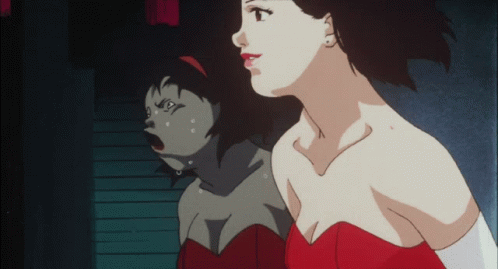 A Woman In A Red Dress Is Looking At Her Reflection In A Mirror GIF
