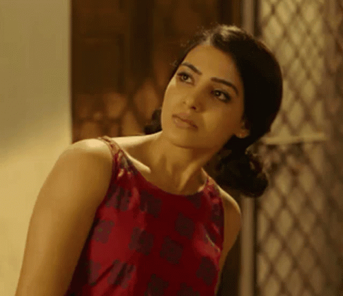 A Woman In A Red Dress Is Looking At Something GIF
