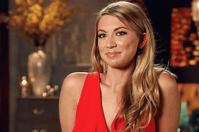 A Woman In A Red Dress Is Making A Face GIF