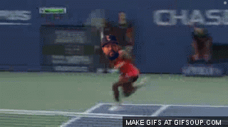A Woman In A Red Dress Is Playing Tennis On A Court With Olympus In The Background GIF