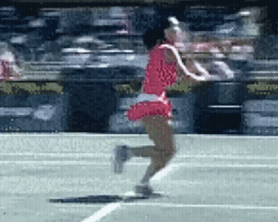 A Woman In A Red Dress Is Running On The Tennis Court GIF
