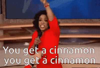 A Woman In A Red Dress Is Singing Into A Microphone With The Words You Get A Cinnamon You Get A Cinnamon GIF