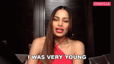 A Woman In A Red Dress Is Sitting On A Couch And Saying I Was Very Young GIF