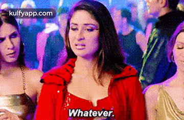 A Woman In A Red Dress Is Standing In A Crowd Of People And Saying Whatever . GIF
