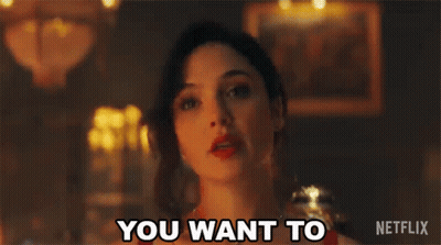 A Woman In A Red Dress Is Standing In A Dark Room And Says `` You Want To '' . GIF