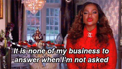 A Woman In A Red Dress Is Standing In A Living Room And Talking About Her Business . GIF