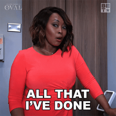 A Woman In A Red Dress Is Standing In Front Of A Door And Says All That I 'Ve Done GIF