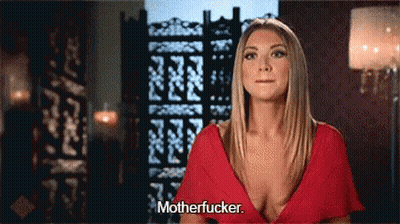 A Woman In A Red Dress Is Standing In Front Of A Screen And Says Motherfucker . GIF