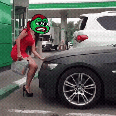 A Woman In A Red Dress Is Standing Next To A Car With A Green Face On It GIF