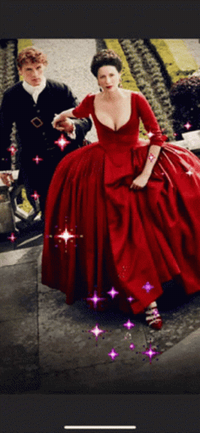 A Woman In A Red Dress Is Walking Next To A Man In A Black Suit GIF