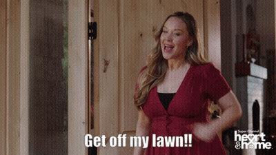 A Woman In A Red Dress Says Get Off My Lawn In Front Of A Door GIF