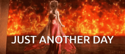 A Woman In A Red Dress Stands In Front Of A Fire With The Words Just Another Day Below Her GIF