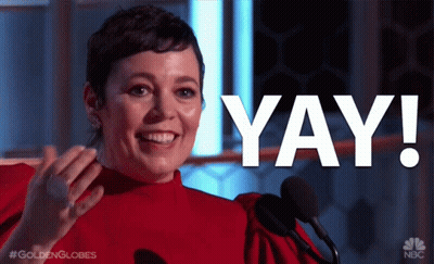 A Woman In A Red Dress Stands In Front Of A Microphone With The Word Yay In White Letters GIF