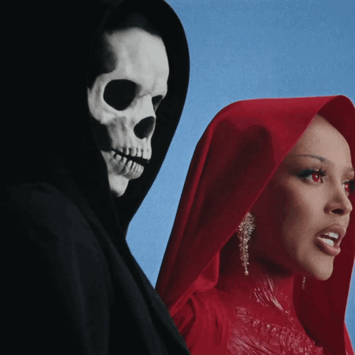 A Woman In A Red Dress Stands Next To A Grim Reaper In A Black Cape GIF
