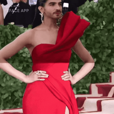 A Woman In A Red Dress With A Man 'S Face On It GIF