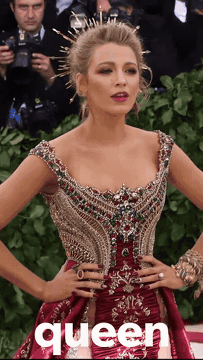 A Woman In A Red Dress With The Word Queen On The Bottom Right GIF
