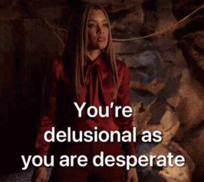 A Woman In A Red Dress With The Words You 'Re Delusional As You Are Desperate Above Her GIF