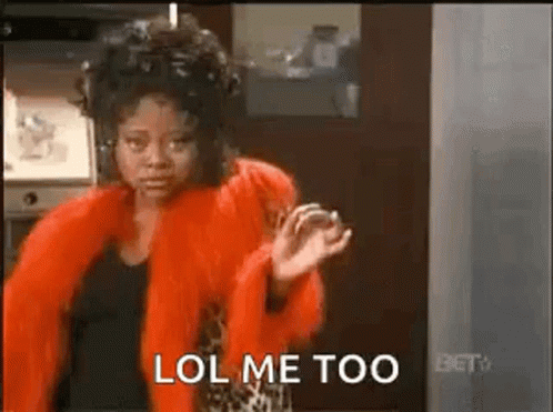 A Woman In A Red Fur Coat Is Standing In A Kitchen And Says Lol Me Too . GIF
