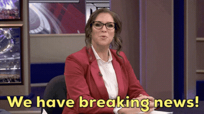 A Woman In A Red Jacket And Glasses Says " We Have Breaking News " GIF