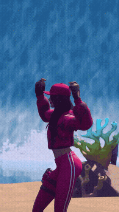 A Woman In A Red Jacket And Red Hat Is Dancing On The Beach GIF