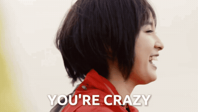 A Woman In A Red Jacket Is Laughing With The Words You 'Re Crazy Above Her GIF