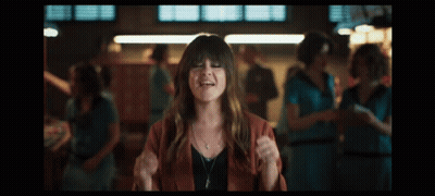 A Woman In A Red Jacket Is Making Funny Faces GIF