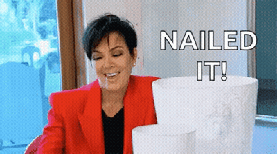 A Woman In A Red Jacket Is Smiling While Holding A Stack Of Toilet Paper Rolls . GIF