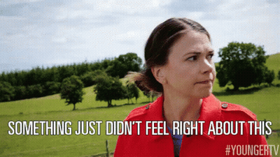 A Woman In A Red Jacket Is Standing In A Field With The Words Something Just Did N't Feel Right About This Above Her GIF