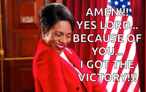 A Woman In A Red Jacket Is Standing In Front Of An American Flag And Says Amen Yes Lord Because Of You I Got The Victory GIF