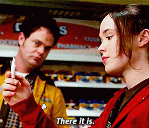 A Woman In A Red Jacket Is Talking To A Man In A Yellow Jacket GIF